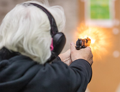 elderly woman at gun range